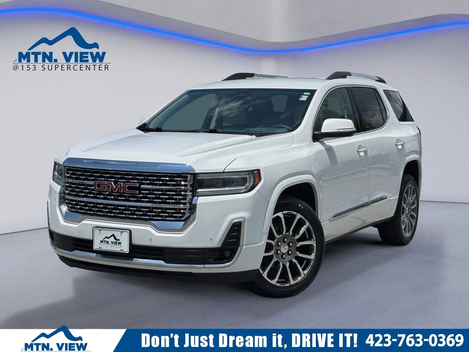 2023 GMC Acadia Denali in Summit White — front three-quarter view